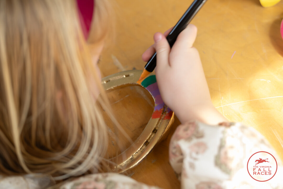 Girl painting horseshoe