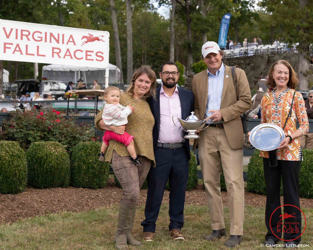 Group of people with trophy and small child