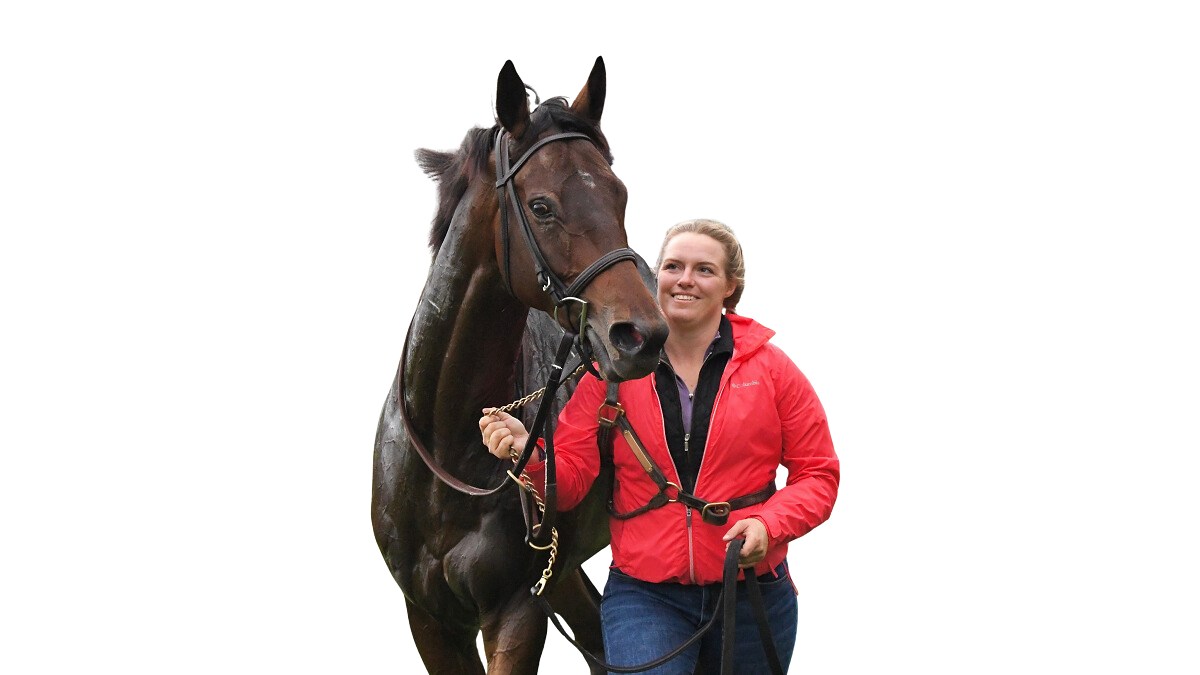smiling woman in red jacket leading racehorse cutout background
